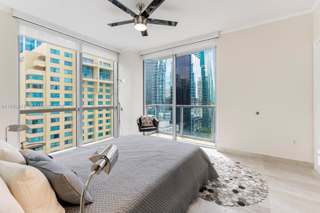 1060 Brickell Avenue, Unit 1507 Miami, FL 33131 - Photo 19 of 56 a bedroom with a large bed and a window