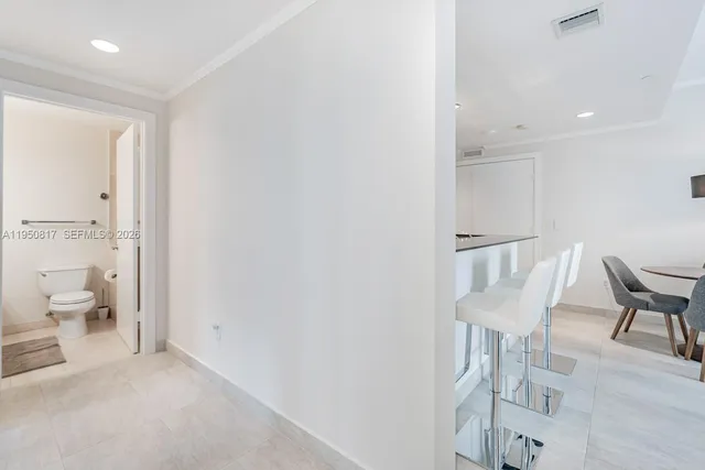a living room with furniture a flat screen tv and a large window