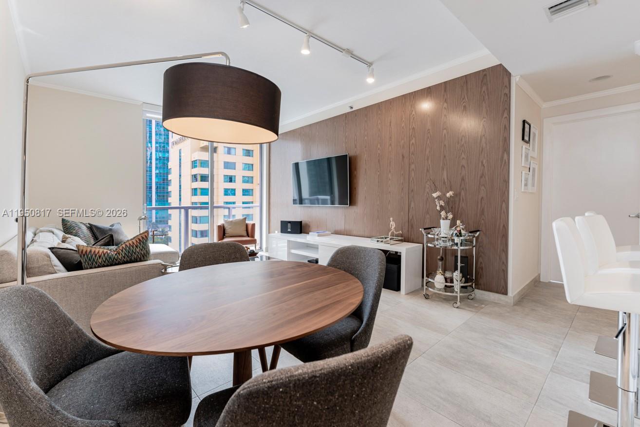 1060 Brickell Avenue, Unit 1507 Miami, FL 33131 - Photo 21 of 56 a living room with furniture a flat screen tv and a large window