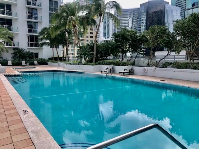 1060 Brickell Avenue, Unit 1507 Miami, FL 33131 - Photo 38 of 56 a swimming pool with outdoor seating and yard
