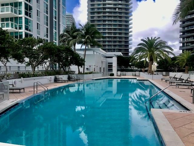 1060 Brickell Avenue, Unit 1507 Miami, FL 33131 - Photo 42 of 56 a swimming pool with outdoor seating and yard