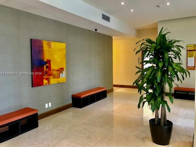 1060 Brickell Avenue, Unit 1507 Miami, FL 33131 - Photo 48 of 56 a living room with furniture potted plant and a potted plant