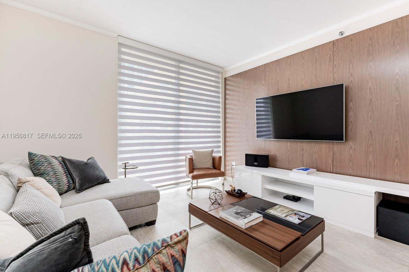 1060 Brickell Avenue, Unit 1507 Miami, FL 33131 - Photo 5 of 56 a living room with furniture and a flat screen tv