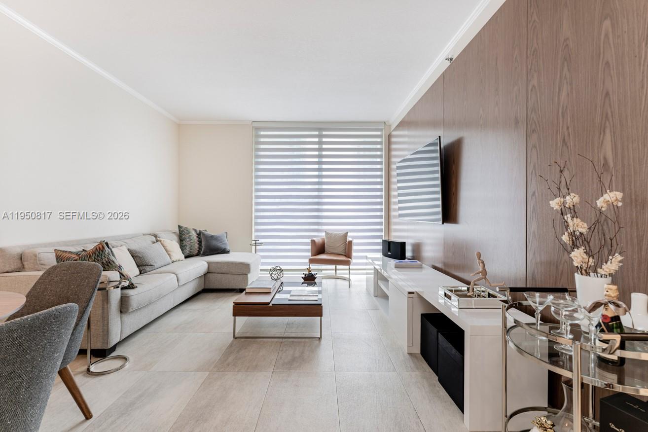 1060 Brickell Avenue, Unit 1507 Miami, FL 33131 - Photo 6 of 56 a living room with furniture and a flat screen tv