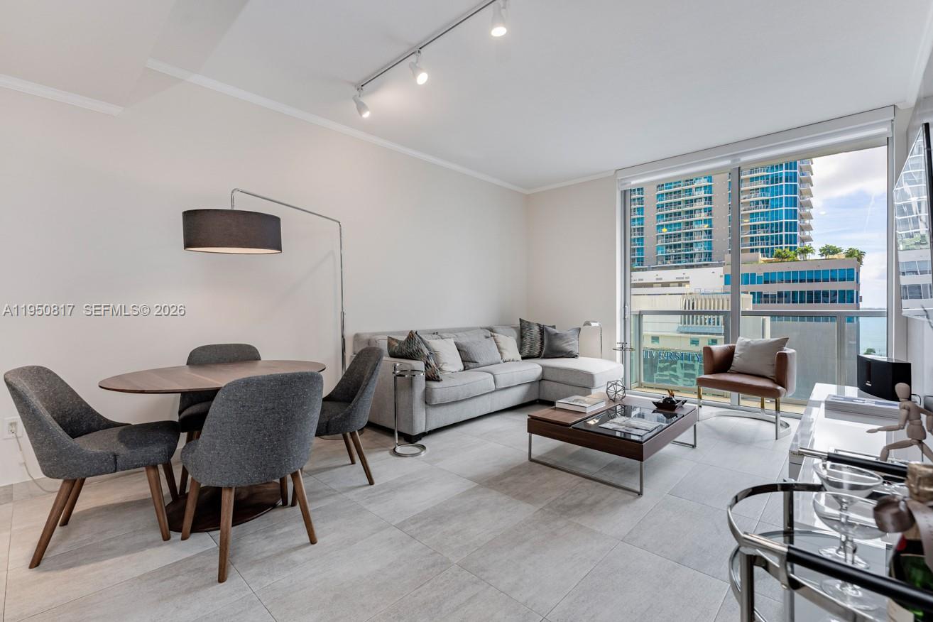 1060 Brickell Avenue, Unit 1507 Miami, FL 33131 - Photo 7 of 56 a living room with furniture and a floor to ceiling window