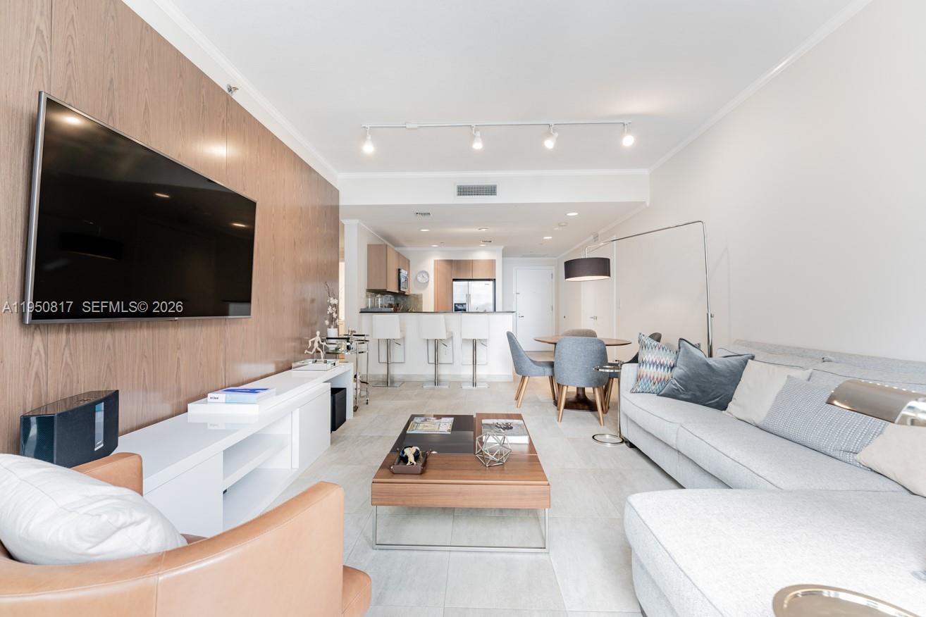1060 Brickell Avenue, Unit 1507 Miami, FL 33131 - Photo 8 of 56 a living room with furniture and a flat screen tv