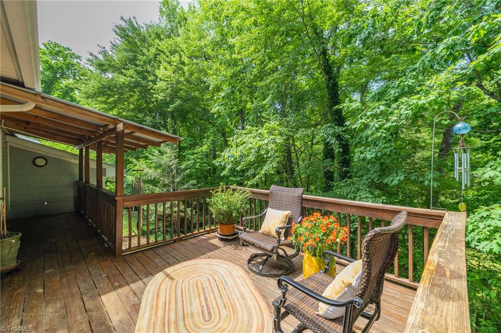1134 Edwards Farm Road King, NC 27021 - Photo 13 of 50 Back deck opens off the main level living room and the studio/sunroom with wonderful views of the sitting pond and surrounding woods.