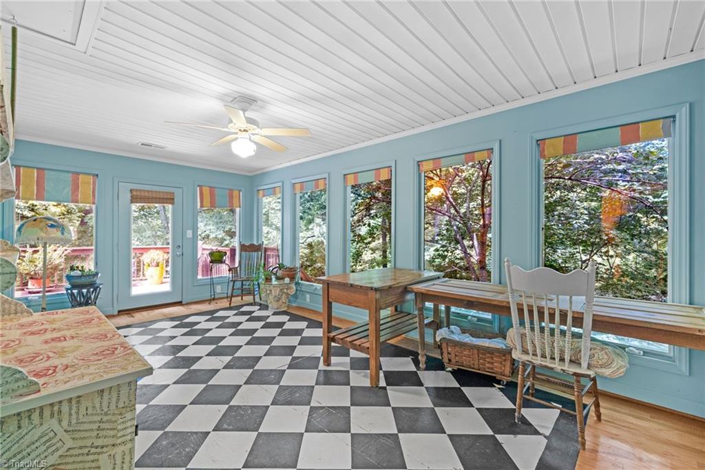 1134 Edwards Farm Road King, NC 27021 - Photo 14 of 50 Just off the main level kitchen, this expansive sunroom functioned as an art studio, but could also be an additional formal dining or additional living room and features roll out casement windows with more of those lovely views of nature.