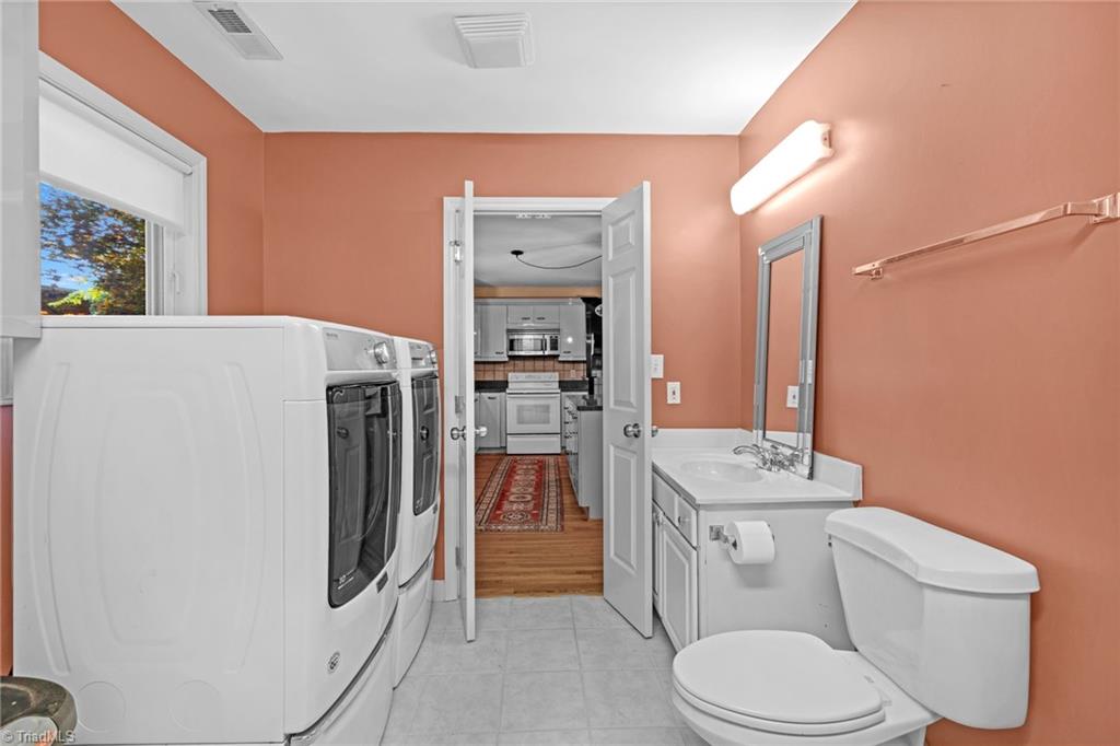1134 Edwards Farm Road King, NC 27021 - Photo 19 of 50 Just off the kitchen is main level laundry room with half bath and additional pantry storage room