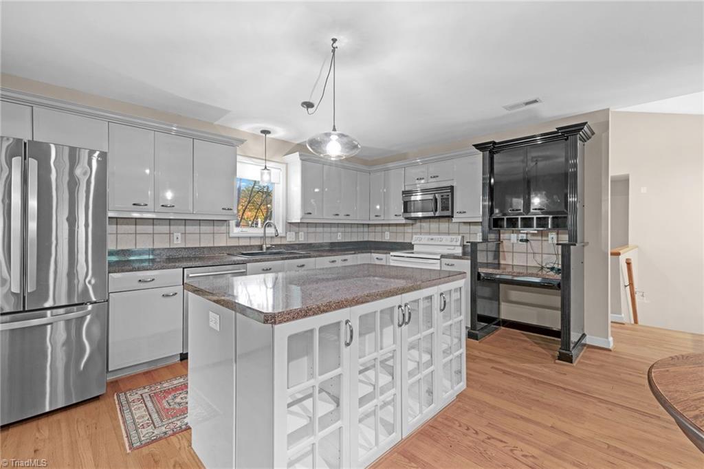 1134 Edwards Farm Road King, NC 27021 - Photo 10 of 50 Kitchen complete with ample cabinet storage, great island with additional storage. Refrigerator, washer & dryer remain with the home.