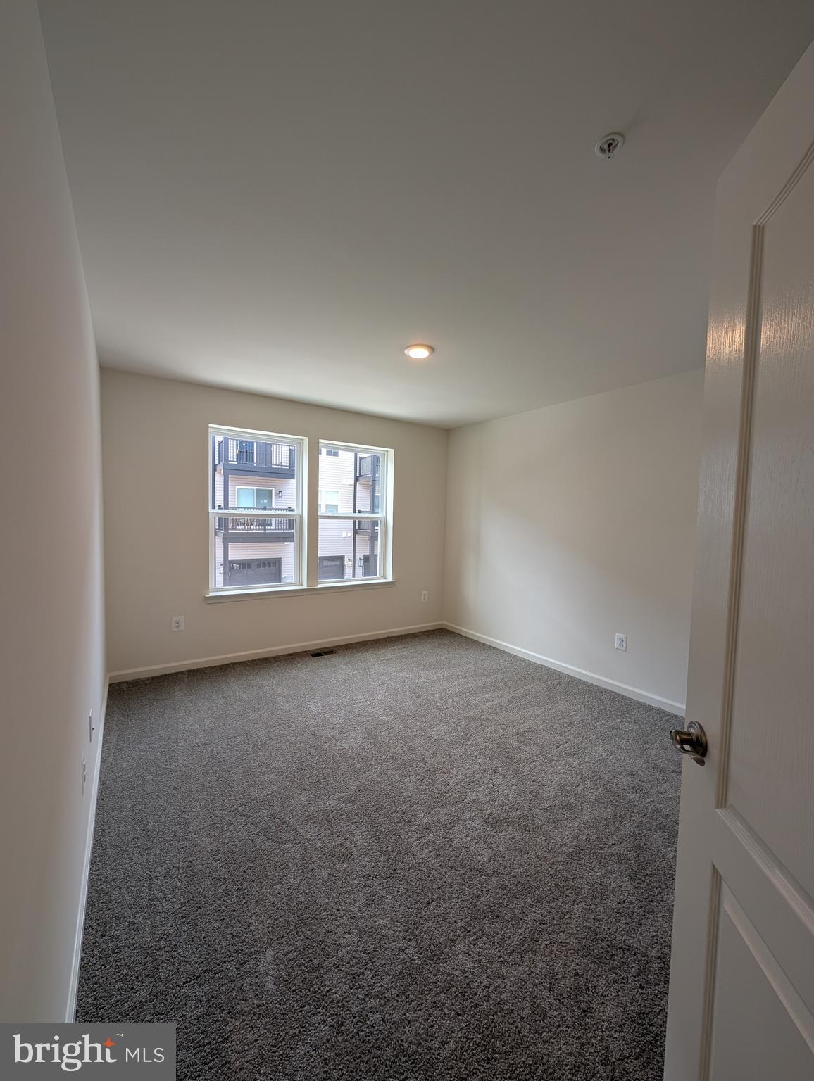 9985 A Justify Run Laurel, MD 20723 - Photo 12 of 33 a view of a big room with windows and chandelier fan