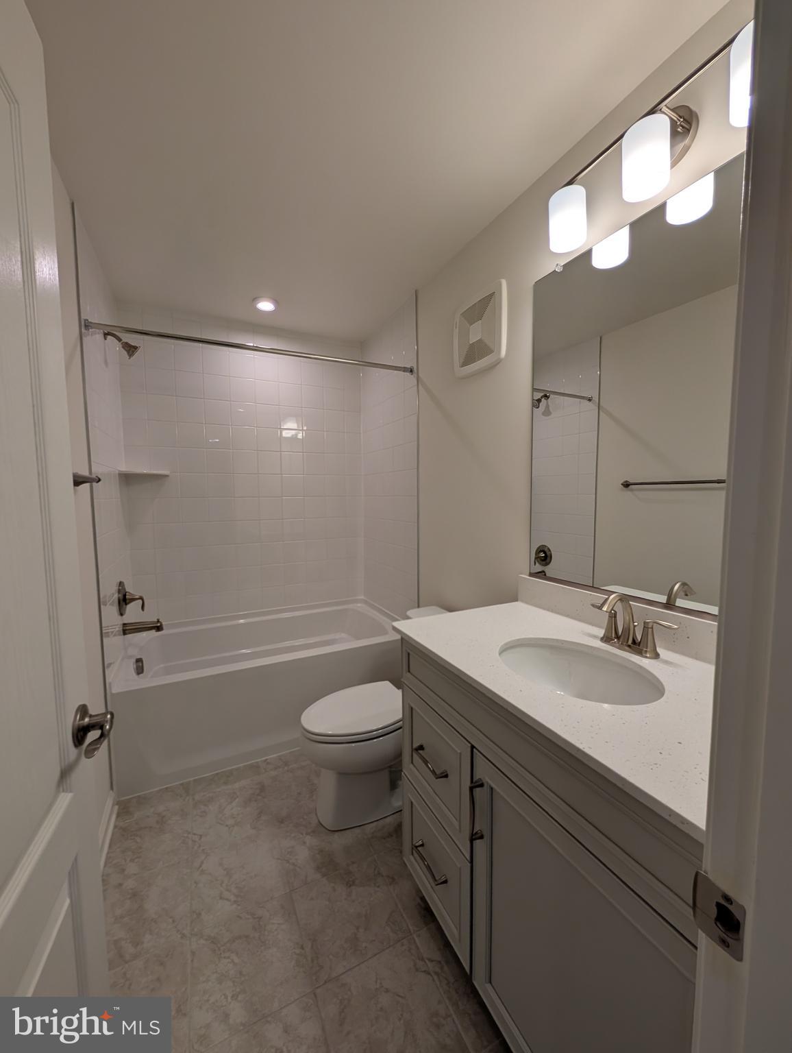 9985 A Justify Run Laurel, MD 20723 - Photo 13 of 33 a bathroom with a sink a toilet and shower