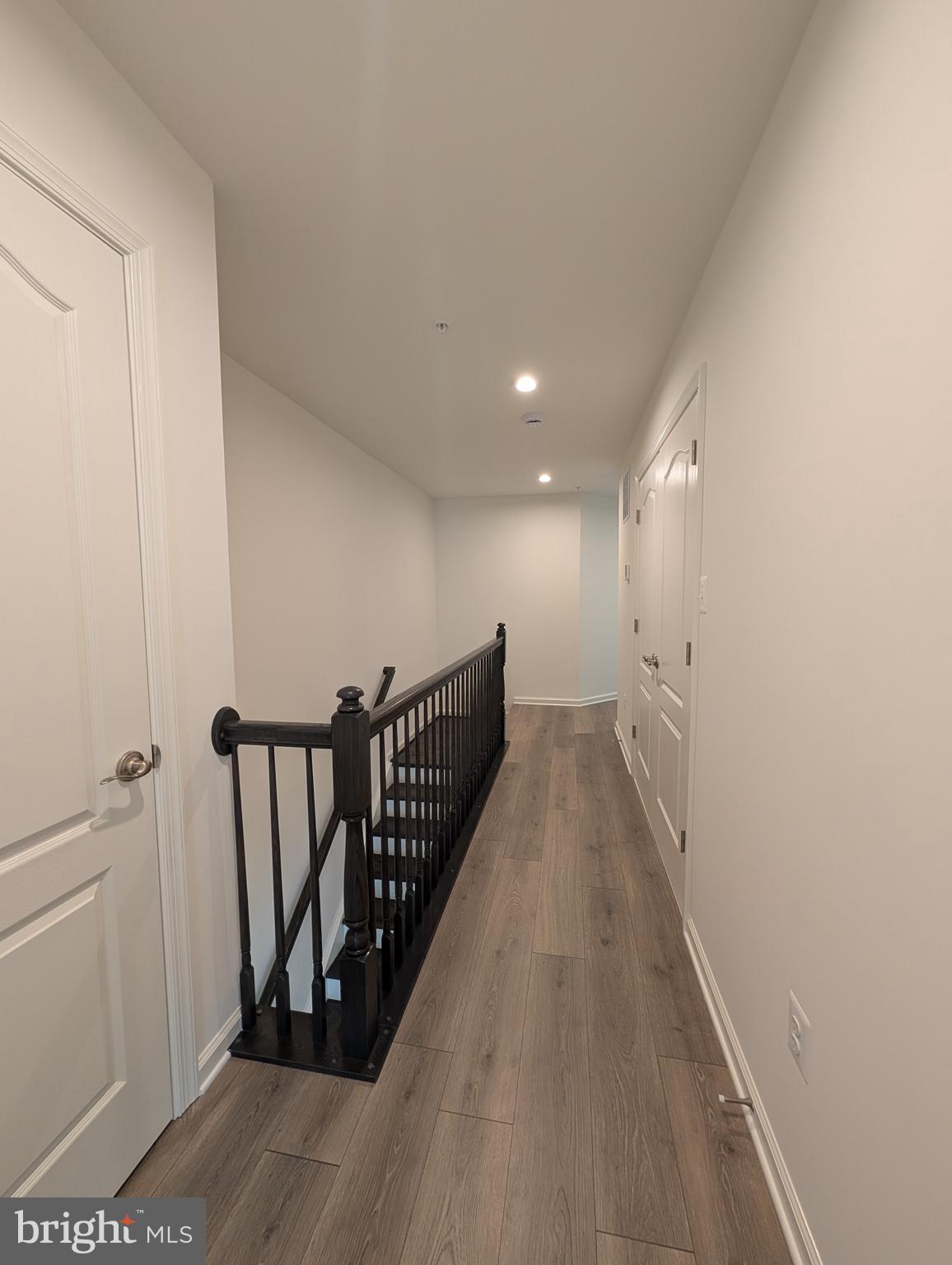 9985 A Justify Run Laurel, MD 20723 - Photo 22 of 33 a view of a hallway with wooden floor and stairs