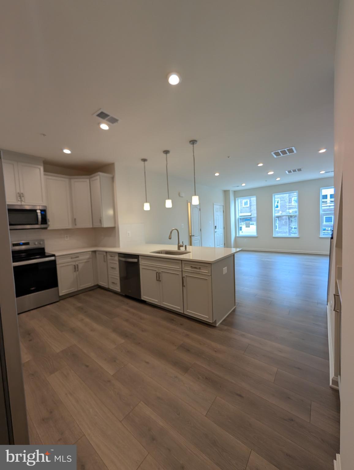 9985 A Justify Run Laurel, MD 20723 - Photo 4 of 33 a large kitchen with stainless steel appliances granite countertop a large counter top a sink and a refrigerator