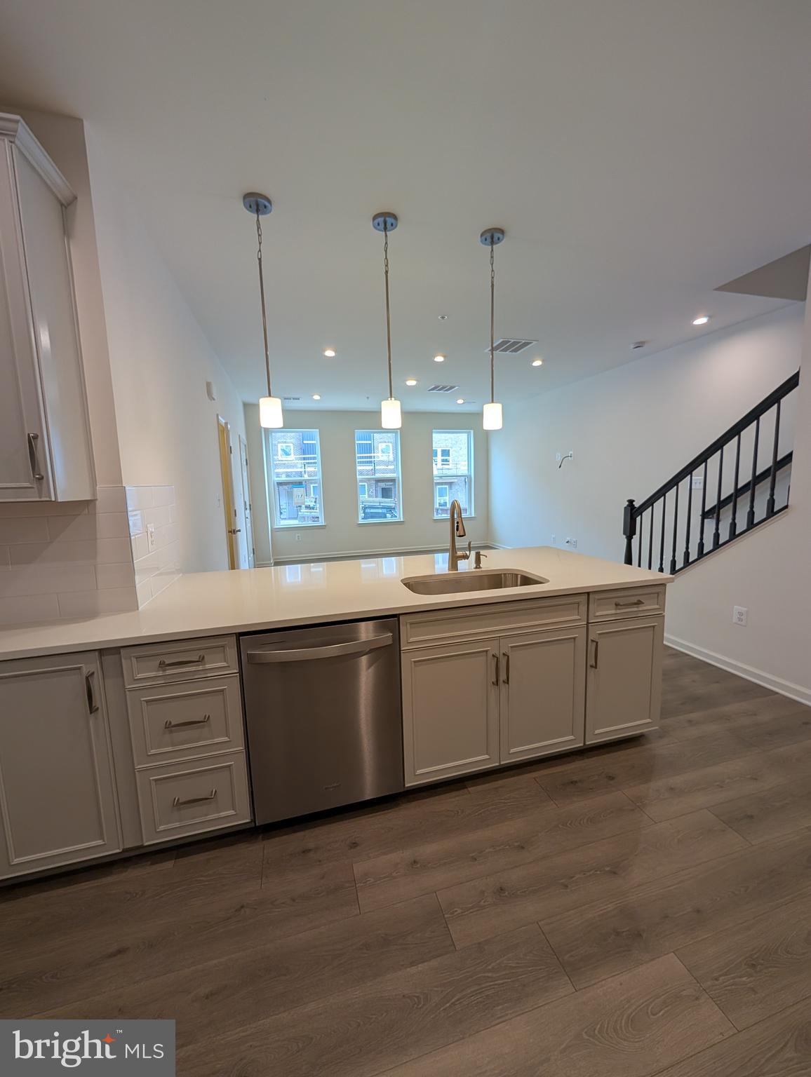 9985 A Justify Run Laurel, MD 20723 - Photo 33 of 33 a large kitchen with kitchen island a stove a sink a center island and wooden floor