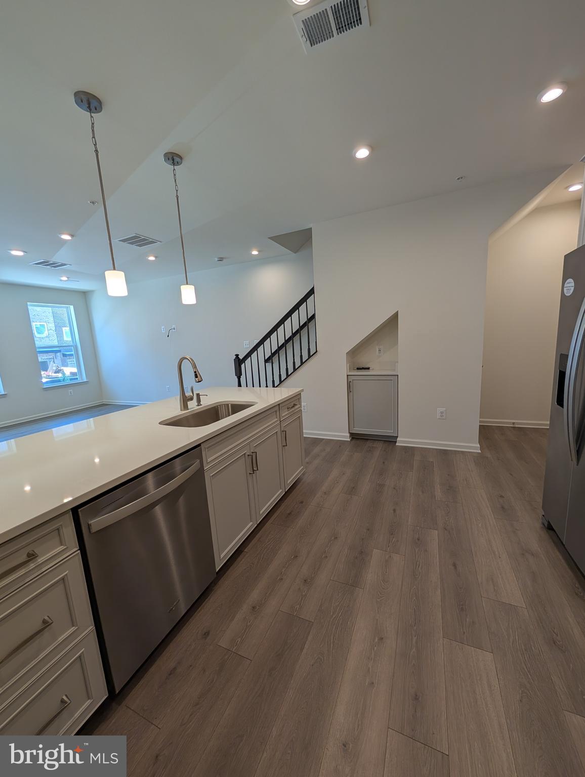 9985 A Justify Run Laurel, MD 20723 - Photo 6 of 33 a large kitchen with a large counter top a sink a window and stainless steel appliances