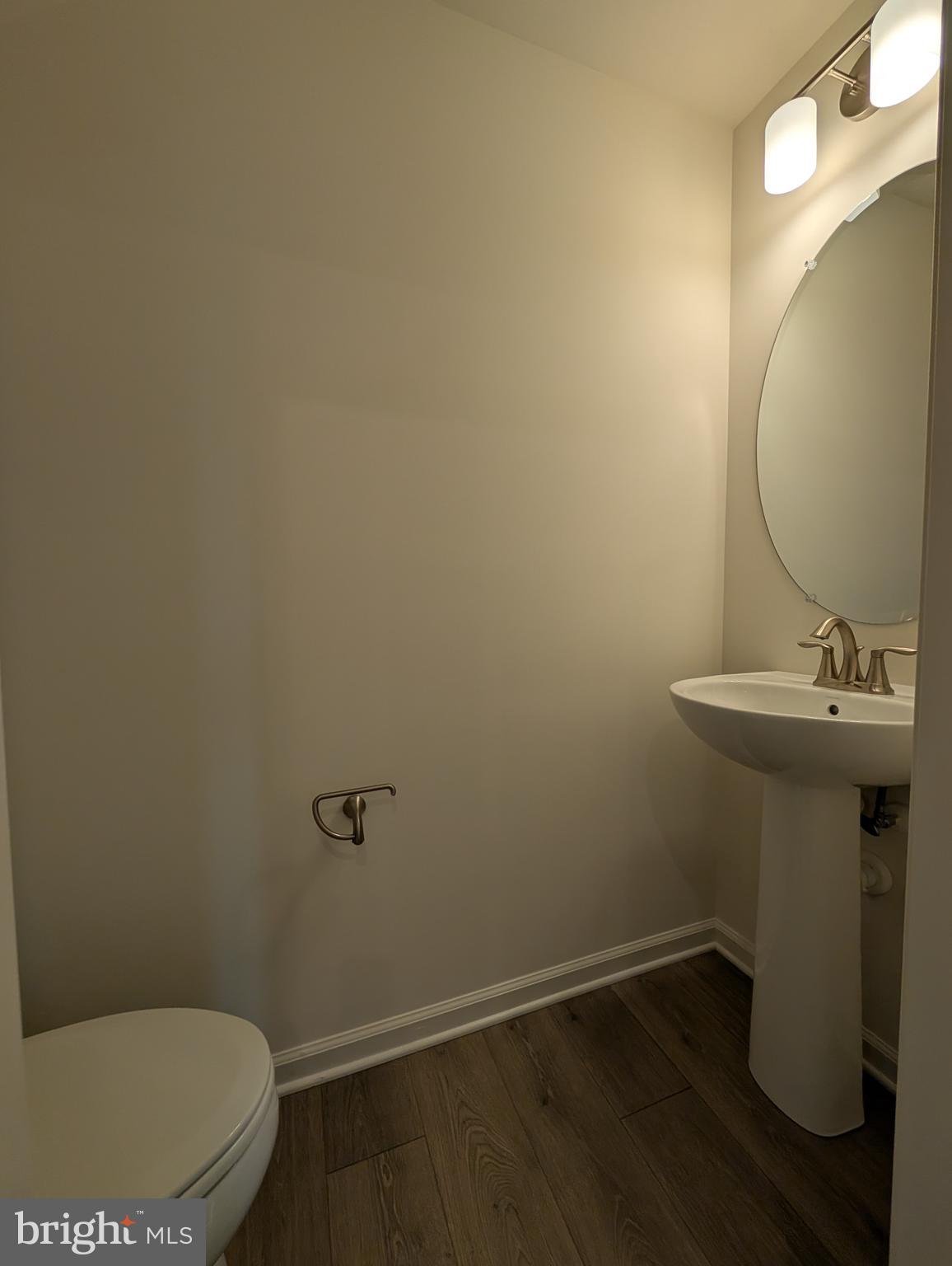 9985 A Justify Run Laurel, MD 20723 - Photo 8 of 33 a bathroom with a sink toilet and vanity