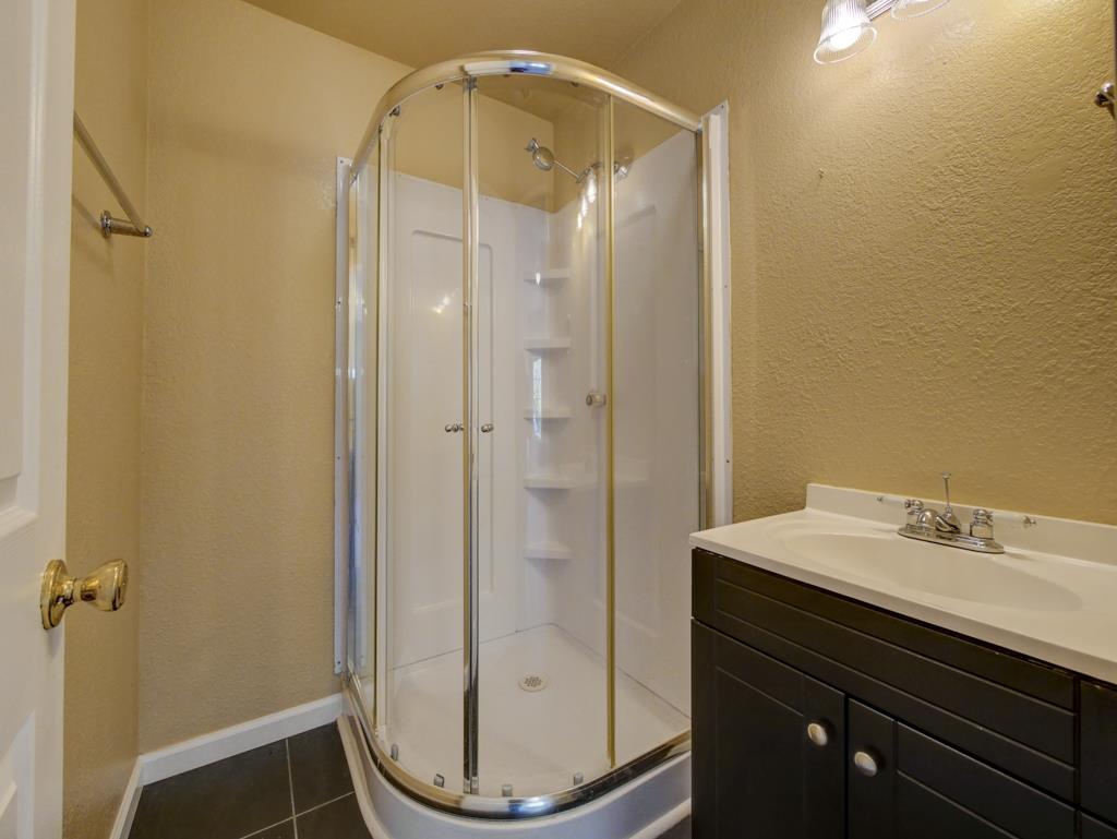 195 Corralitos View Road Watsonville, CA 95076 - Photo 32 of 34 a bathroom with a shower a sink and a mirror
