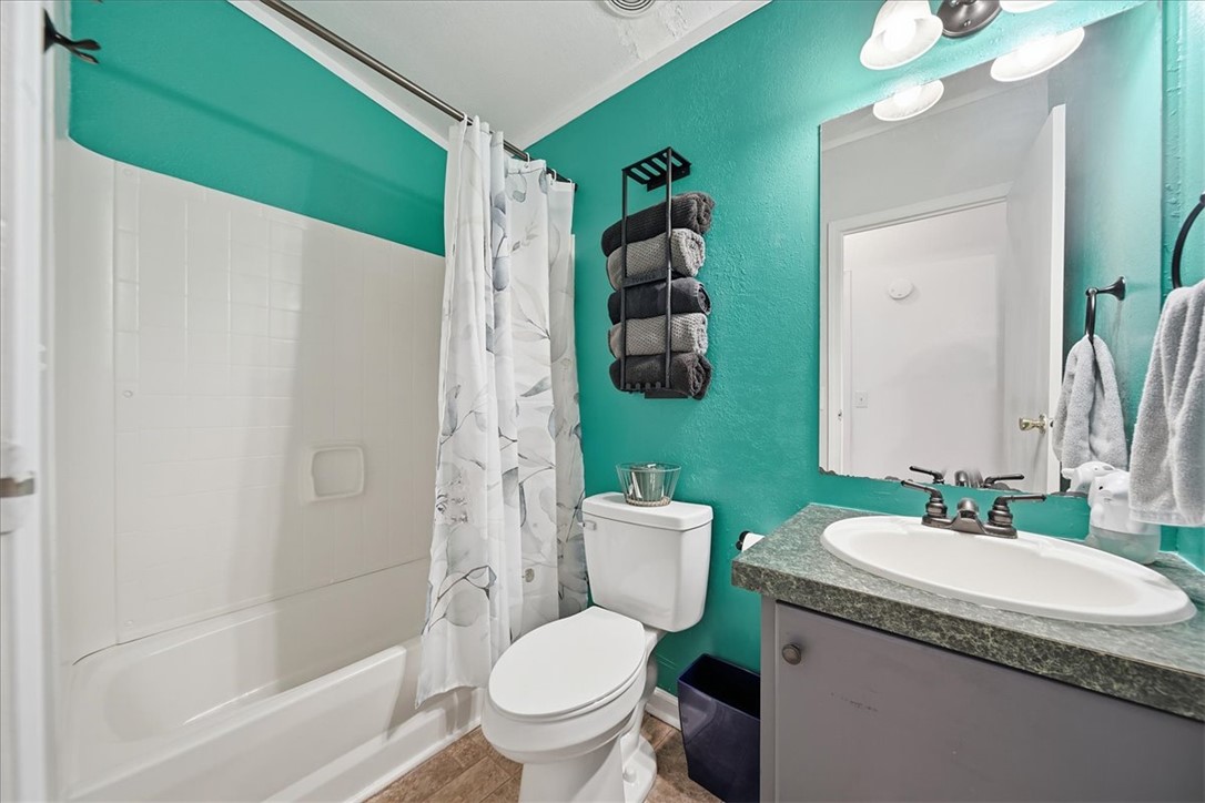 1014 Harris Road Anderson, SC 29625 - Photo 19 of 34 A well-lit bathroom with a bright accent wall and durable tile flooring.