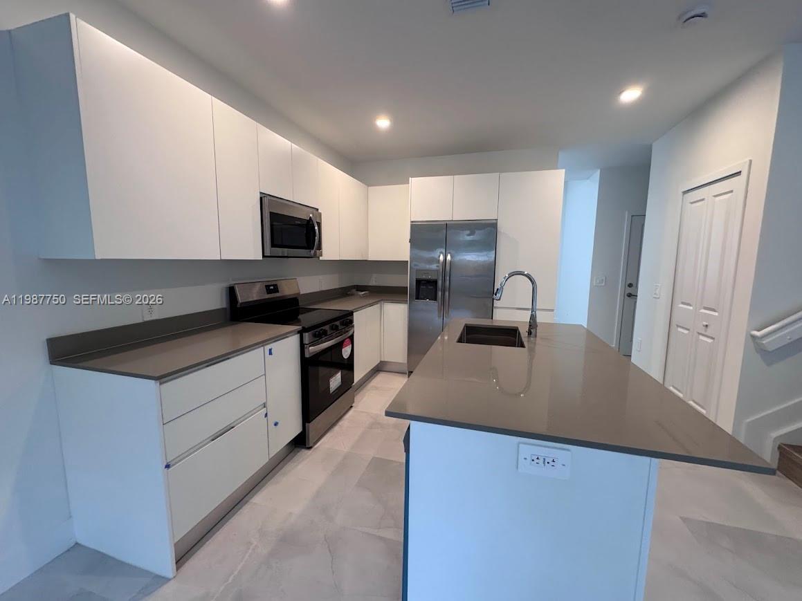 34435 Southwest 189th Court Homestead, FL 33030 - Photo 21 of 28 a kitchen with a sink stove and refrigerator