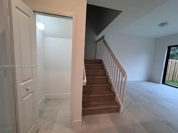 an empty room with windows and closet