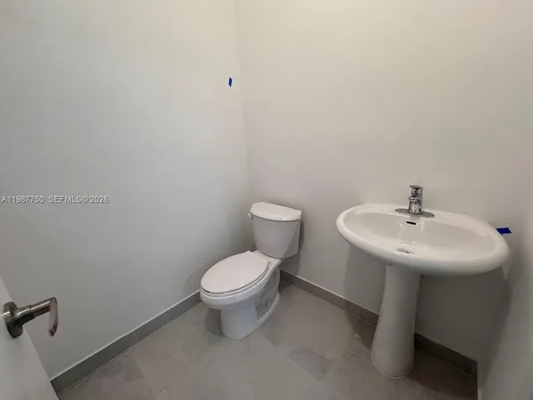 a bathroom with a sink toilet and a mirror