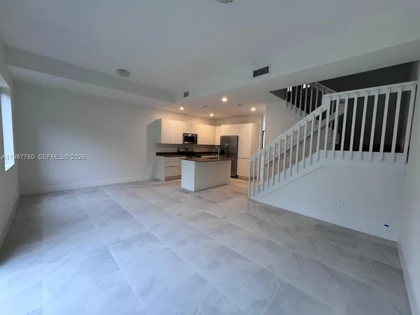 a view of a hallway with kitchen