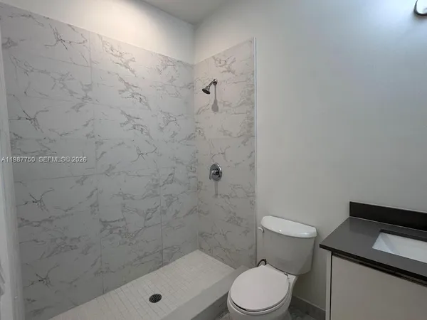 a white toilet and a shower in a bathroom