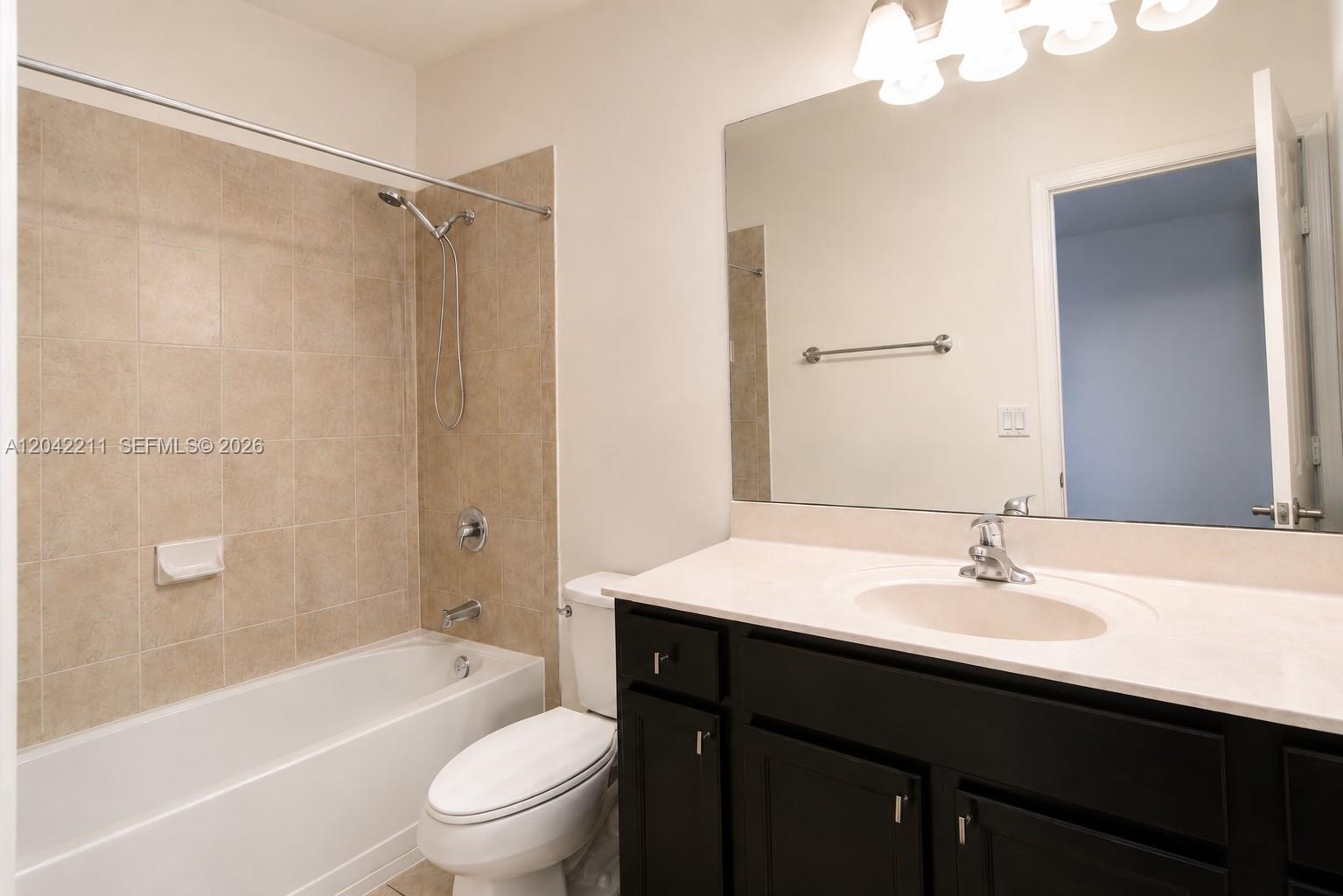 8954 West 35th Way Hialeah, FL 33018 - Photo 19 of 24 a bathroom with a sink a toilet and shower