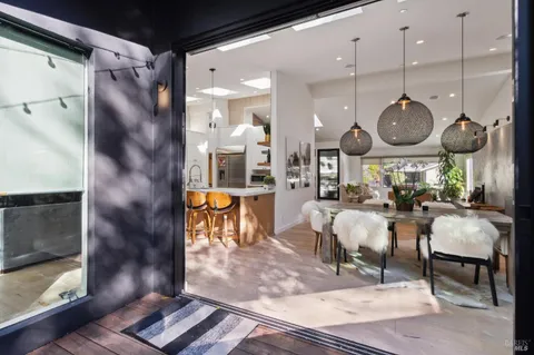 a view of living room and dining room with wooden floor