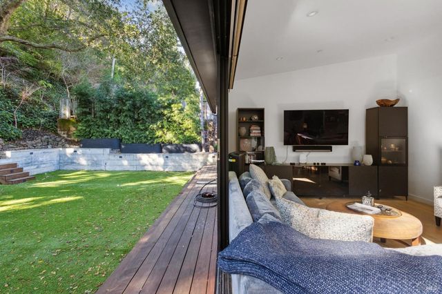 a living room with lots of furniture and a view of kitchen
