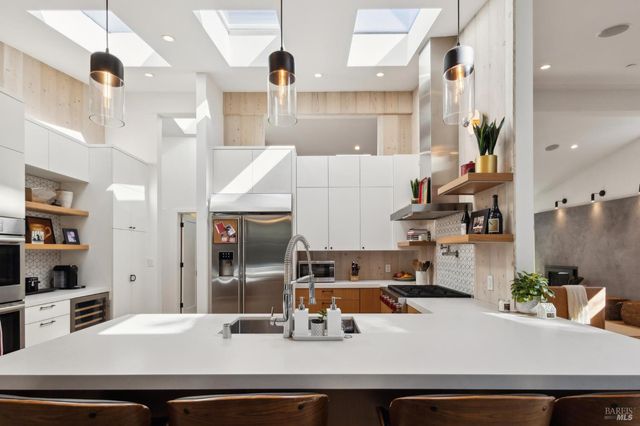 a kitchen with stainless steel appliances granite countertop a sink and cabinets