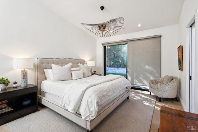 a bedroom with a bed and a night stand