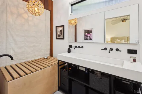 a bathroom with a sink mirror and a shower