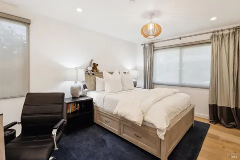 a bedroom with bed and a chandelier