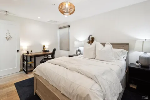 a bedroom with a large bed and a window