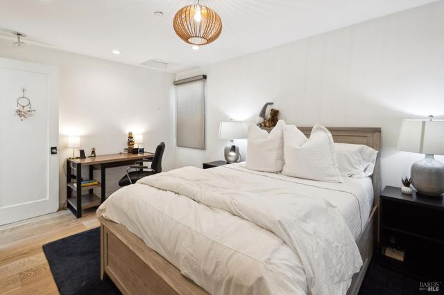 a bedroom with a large bed and a window