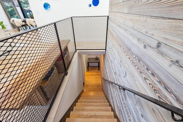 a bed room with a bed and painting on the wall