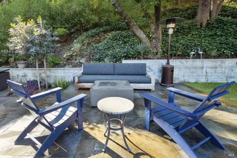 a view of a swimming pool with an outdoor seating and a yard