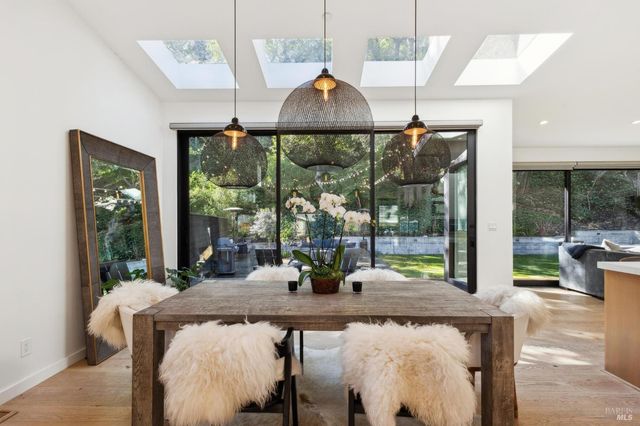a dining room with furniture a chandelier and wooden floor