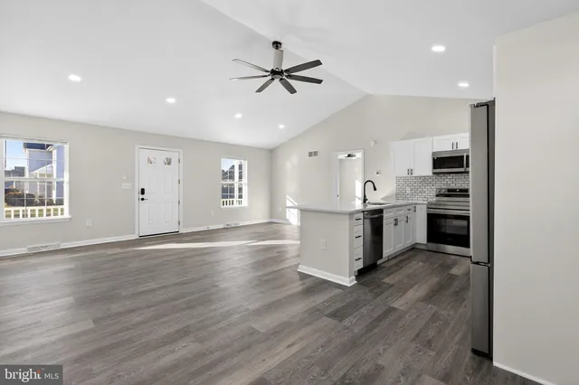 a view of kitchen with sink refrigerator and microwave