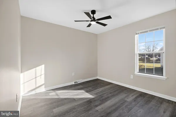 a view of an empty room and wooden floor