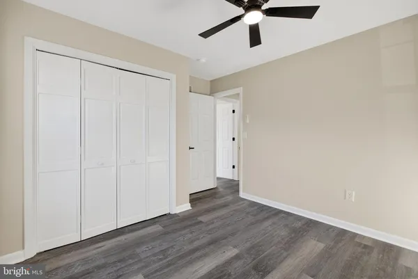 a view of a livingroom with a ceiling fan and window