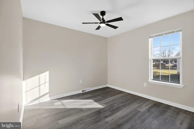 a view of an empty room and wooden floor