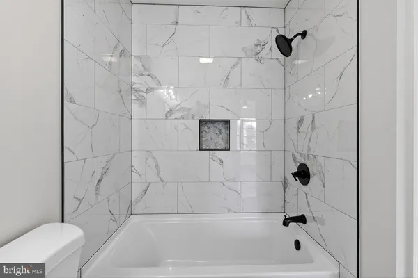 a bathroom with a toilet sink vanity and mirror