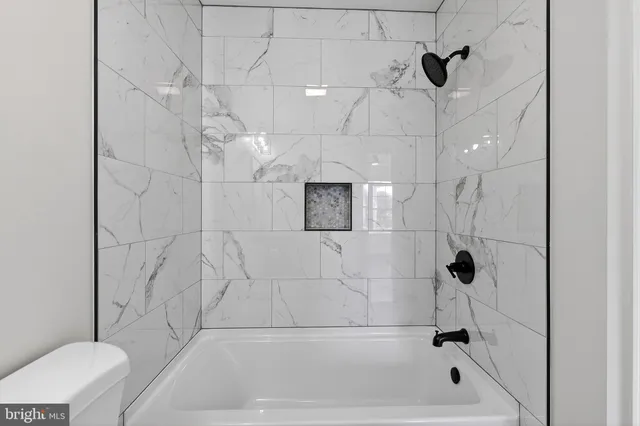 a bathroom with a toilet sink vanity and mirror