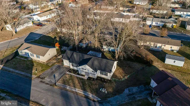 an aerial view of a houses with yard