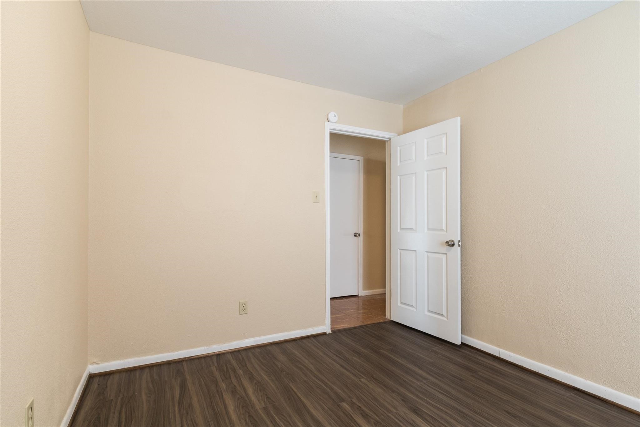 3823 Heatherbrook Drive Houston, TX 77045 - Photo 7 of 11 a view of an empty room with wooden floor