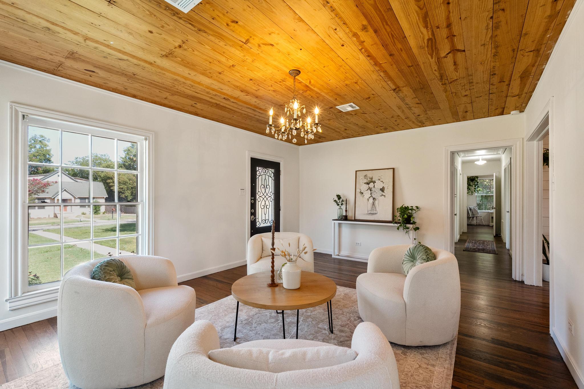 1707 Lexington Street Taylor, TX 76574 - Photo 1 of 29 a living room with furniture and a chandelier