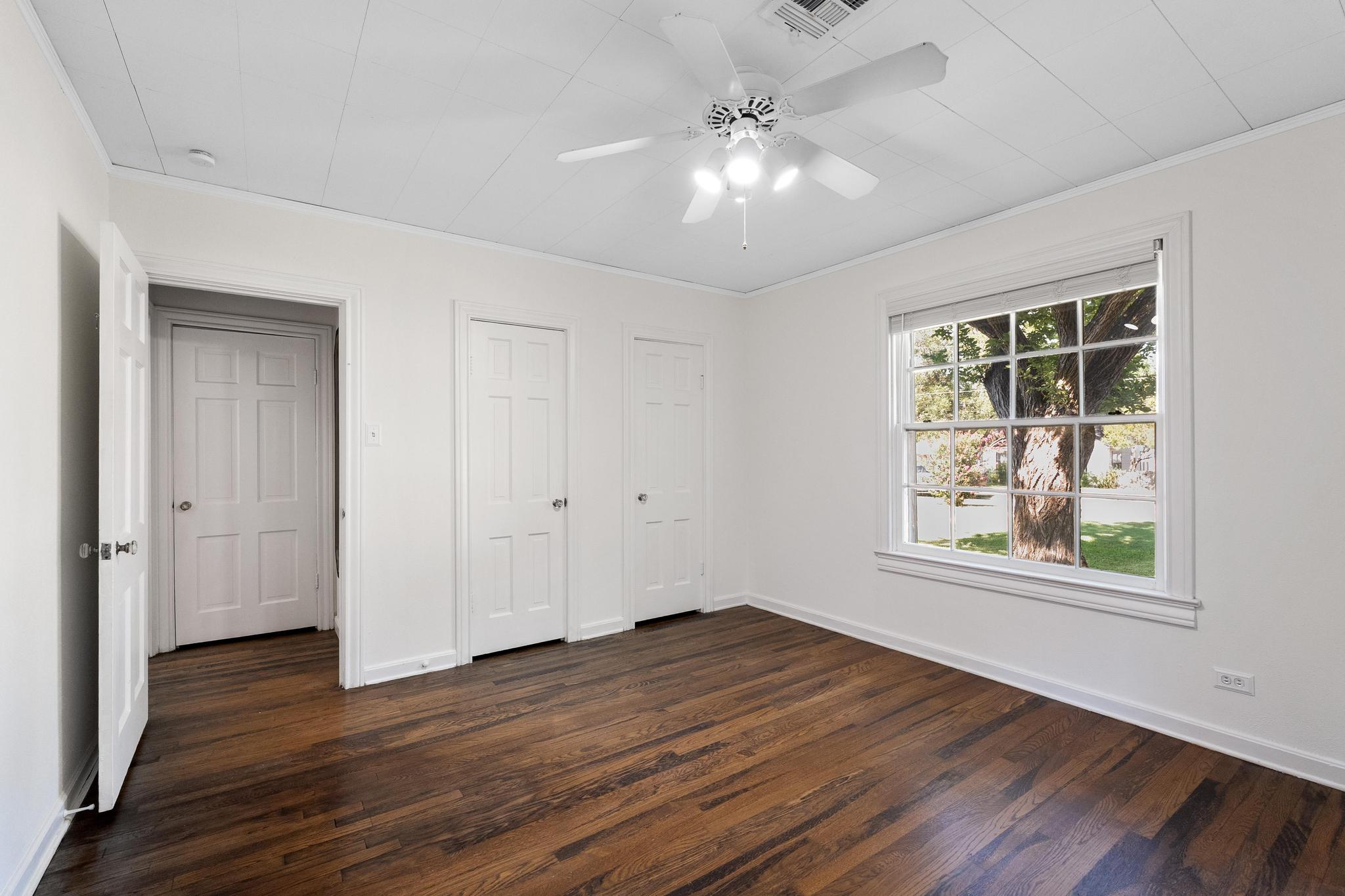1707 Lexington Street Taylor, TX 76574 - Photo 16 of 29 a view of an empty room with wooden floor and a window